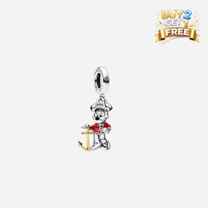 May include: A silver charm featuring Mickey Mouse in a red jacket and white pants, holding a gold anchor. The charm has a loop for attaching to a bracelet or necklace. A banner in the top right corner reads "BUY 2 GET 1 FREE".