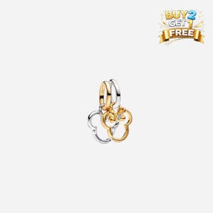 May include: A gold and silver charm featuring two Mickey Mouse head silhouettes. One charm is gold-toned, the other is silver-toned. The charms are connected by a gold and silver ring. A small diamond-like stone is set in the gold charm.