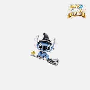 May include: A blue and silver charm depicting a cartoon character in a witch's hat, riding a broom. A small yellow pumpkin is attached to the broom. The charm has black eyes and a blue outfit.