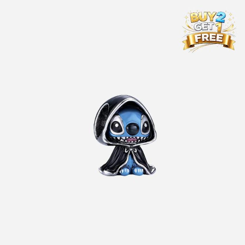 May include: A blue and black charm featuring a cartoon character wearing a black hooded cloak. The charm has a silver-colored trim and a smiling expression. The text "BUY 2 GET 1 FREE" is in the upper right corner.
