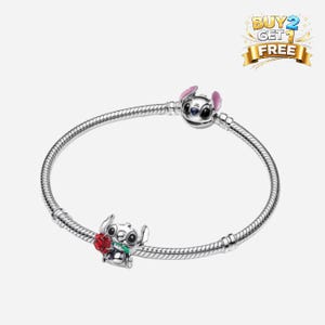 May include: A white ceramic mug with a black handle and the text "But First, Coffee" in a bold, black font. The mug is set against a neutral background, highlighting its simple design.