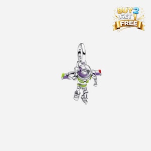 May include: A silver charm of Buzz Lightyear from Toy Story. The charm has a detailed design with green, purple, red, and white enamel accents. It features a loop at the top for attaching to a bracelet or necklace.