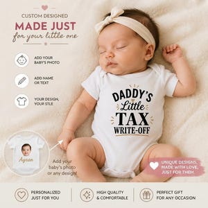 May include: A white baby bodysuit featuring the black and gold text DADDY'S Little TAX WRITE-OFF. The garment is worn by a sleeping infant with a cream-colored headband. The image includes instructional text about adding photos and custom designs.