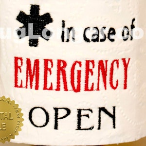 May include: A white toilet paper roll with black and red embroidery that reads "In case of emergency open". A gold seal with the text "Not a physical item, digital file" is on the bottom left corner.