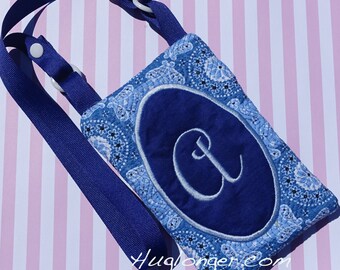May include: A blue and white paisley patterned phone pouch with a blue oval containing a white embroidered letter "A". The pouch has a blue adjustable strap.