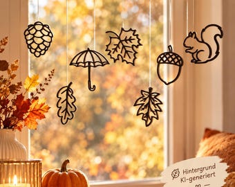May include: A set of dark brown hanging ornaments suspended from a wooden branch, featuring cutout shapes of a pinecone, an umbrella, a maple leaf, an oak leaf, an acorn, and a squirrel, all connected by thin white strings for seasonal display.