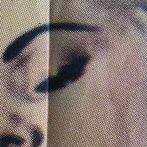 May include: Close-up of a person's eye with black eyeliner and a light brown background.