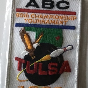 May include: White embroidered patch with the text "ABC 90th Championship Tournament Tulsa 1993". The patch features a bowling ball, bowling pin, and an eagle.