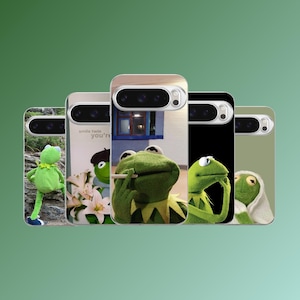 May include: A collection of phone cases featuring Kermit the Frog in various poses. The cases display images of Kermit with different backgrounds, including a photo of Kermit holding a cigarette, and a Kermit plush toy. The cases have a camera cutout.