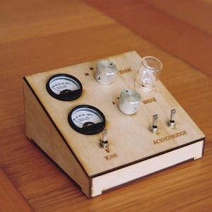 May include: A wooden electronic device featuring two circular gauges, silver knobs, toggle switches, and a small glass cylinder. The text "TONE" and "ACID/CHORUS" are visible. The device is on a wooden surface.