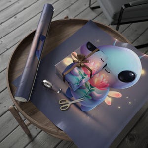 May include: A wrapped gift on blue floral paper, featuring a cartoon character illustration. A roll of matching paper, scissors, and tape are on a wooden table. The gift is tied with a brown ribbon.