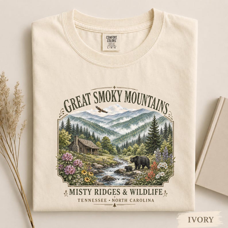 Nature tee featuring bears, wildflowers, stream, and misty mountain ridges