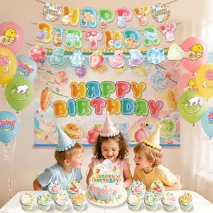 May include: A birthday party scene featuring a colorful Happy Birthday banner, assorted pastel balloons with cartoon graphics, and a decorated cake with a party hat topper. Three children sit at a table with cupcakes in front of them.