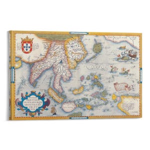 May include: A framed vintage map of Southeast Asia, featuring detailed illustrations and text in Latin. The map is bordered in gold and includes a coat of arms and nautical illustrations. The overall color palette is muted, with beige, blue, and gold tones.