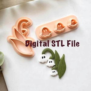 Puede incluir: Se muestran varios cortadores de galletas de plástico rosa, incluyendo una flor, fantasmas y un lirio de los valles. También hay un lirio de los valles terminado con flores blancas y hojas verdes. Se muestra el texto "Digital STL File".