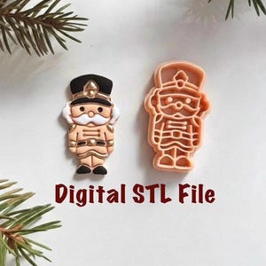 May include: Two nutcracker-themed items. One is a detailed, painted figurine with black, gold, and tan colors. The other is a tan-colored cookie cutter. The text "Digital STL File" is in the image.