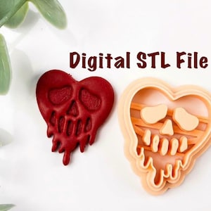 Puede incluir: Un diseño rojo en forma de corazón con una cara de calavera y efecto de goteo, junto a un cortador de galletas en forma de corazón de color melocotón. El texto "Digital STL File" es de color marrón. El diseño está sobre una superficie blanca con hojas verdes.