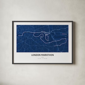 May include: A framed wall art print featuring a dark blue map of the London Marathon route with white street lines. The text below the map reads LONDON MARATHON, LONDON, 42.2 KM, 12 JAN 2024. The print is enclosed in a thin black frame with a white border.