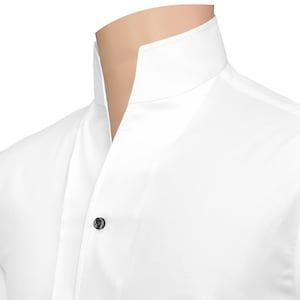 May include: A crisp white shirt featuring a high standing collar and a single dark button visible on the front placket. The garment is shown on a mannequin neck, highlighting the structured neckline and the clean, smooth fabric texture.