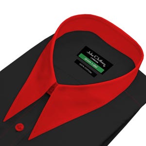 May include: A black long-sleeve shirt featuring a vibrant red collar and a matching red button on the placket. The interior neck label displays the text John Clothier London, Green Label, and 100% Cotton in white and green on a black background.