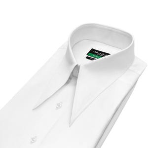 May include: A crisp white dress shirt with a distinctive, pointed collar. The shirt is neatly folded, showcasing its clean lines and buttoned front. A label with the text "John Cloth London" is visible near the collar.