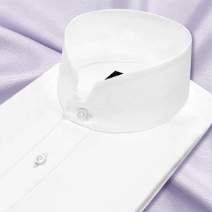 May include: A crisp white dress shirt featuring a high band collar, also known as a mandarin or Nehru collar. The shirt has a front button placket with small white buttons and a smooth, clean finish, showcasing a structured and formal design.