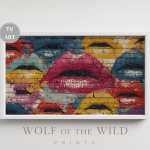 Puede incluir: Impresión enmarcada con arte de graffiti que muestra múltiples labios pintados sobre una pared de ladrillos. La obra utiliza una paleta de colores vibrantes: rojo, rosa, amarillo y azul. El texto "TV ART" está en la esquina superior izquierda.
