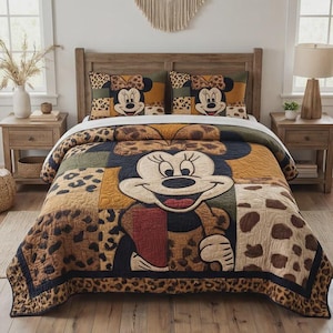 May include: A patchwork quilt and two pillowcases featuring Minnie Mouse. The quilt has a large Minnie Mouse face in the centre, surrounded by leopard print and other patterns. The pillowcases have Minnie Mouse faces and leopard print.
