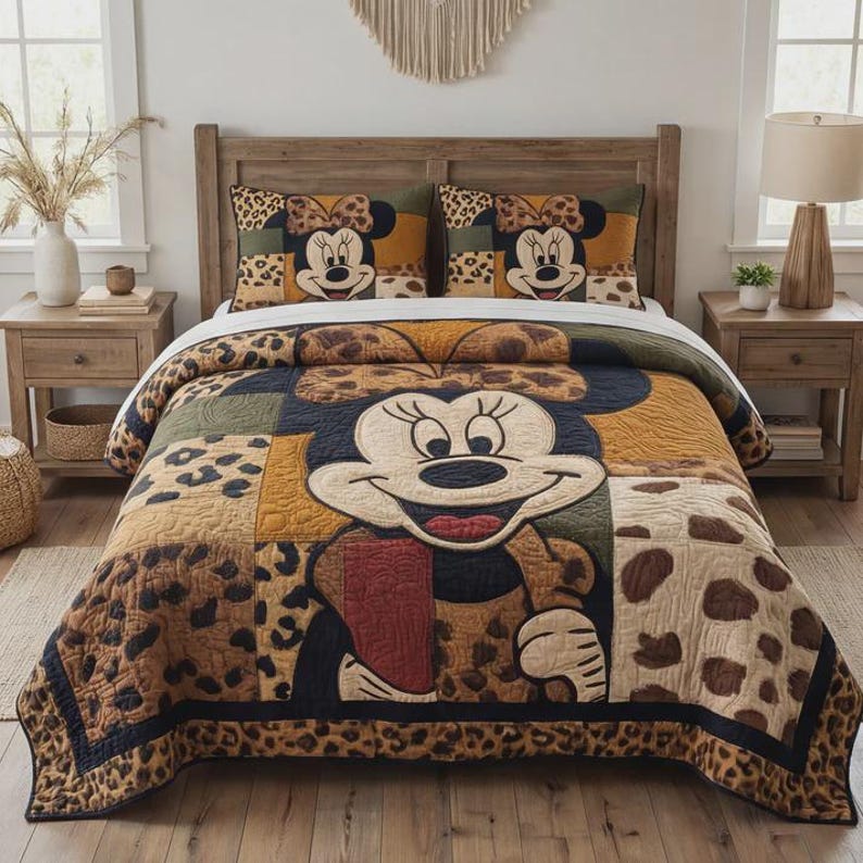 May include: A patchwork quilt and two pillowcases featuring Minnie Mouse. The quilt has a large Minnie Mouse face in the centre, surrounded by leopard print and other patterns. The pillowcases have Minnie Mouse faces and leopard print.
