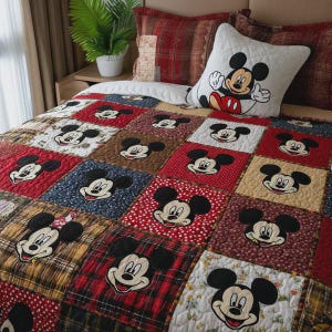 Puede incluir: Un juego de edredón y almohada de patchwork con Mickey Mouse. El edredón tiene cuadrados en rojo, marrón, azul y amarillo, cada uno con una cara de Mickey Mouse. La almohada muestra a Mickey haciendo una señal de pulgar.