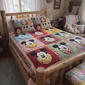 May include: A colourful patchwork quilt and matching pillow set featuring Mickey Mouse. The quilt is made of squares, each with a different Mickey Mouse design. The bed frame is made of light-coloured wood.