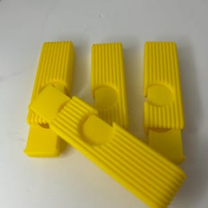 May include: A white ceramic mug with a black handle and the text "But First, Coffee" in a black, handwritten-style font. The mug is on a white surface.