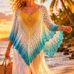 May include: A crochet poncho in a gradient of colors, from yellow to white to turquoise. The open-weave design features a V-neck and scalloped edges. The poncho is worn over a white dress, with a straw bag in hand, on a beach at sunset.