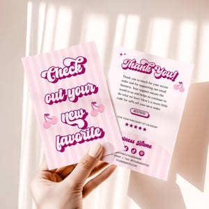 May include: Two pink cards with a striped background and cherry illustrations. One card reads "Check out your new favorite" in a retro font. The other card says "Thank You!" and includes a discount code and social media handles.