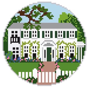 May include: A circular cross-stitch pattern depicting a white two-story house with dark green shutters, a dark green front door, and a gray roof. The house is surrounded by green trees, climbing vines, and pink flowers, with a white picket fence in front.