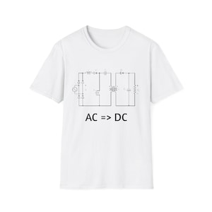 May include: White t-shirt with a black schematic diagram and the text "AC => DC". The diagram depicts an electrical circuit, likely related to converting alternating current to direct current. The shirt is made of a soft, comfortable material.