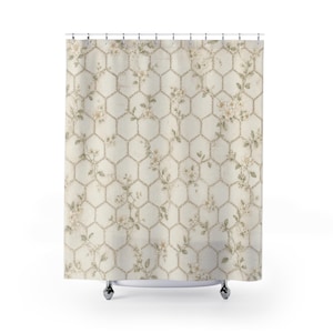 May include: A shower curtain featuring a cream-colored background with a repeating brown hexagonal wire fence pattern. Intertwined with the geometric grid are delicate, light-colored floral vines with small leaves and blossoms throughout the fabric.