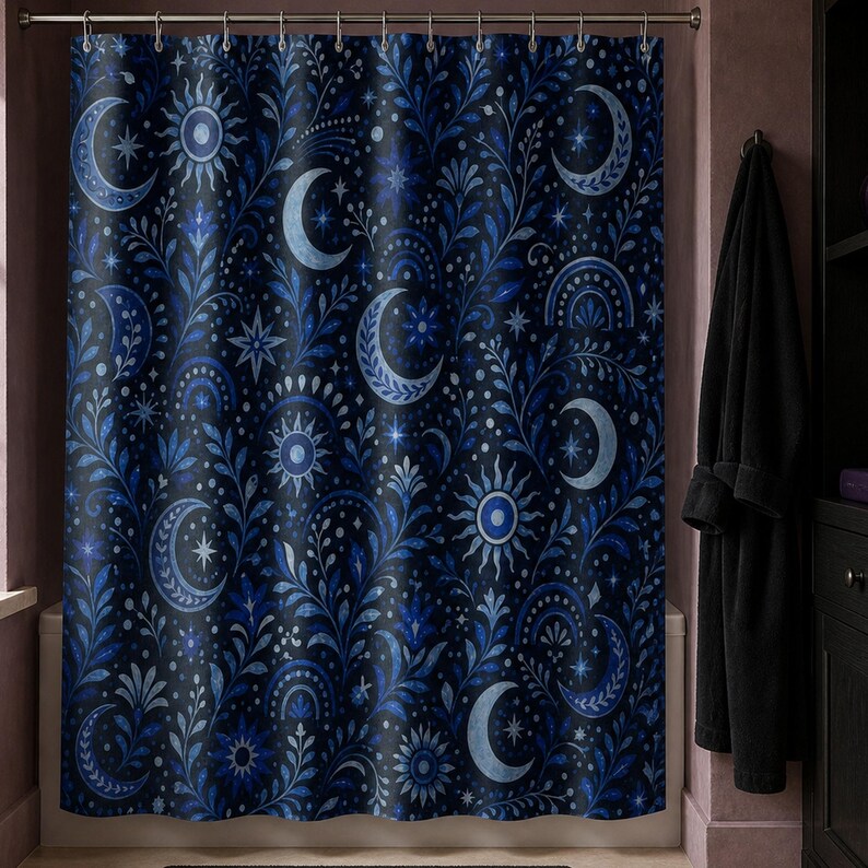 Navy celestial moon and sun shower curtain in a tarot reader brownstone bathroom with mauve walls and black robe