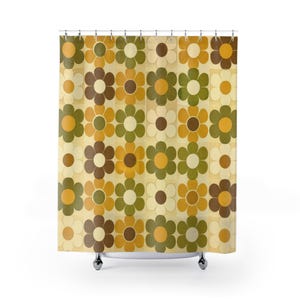 May include: A shower curtain featuring a repeating floral pattern in shades of mustard yellow, olive green, dark brown, and cream. The design consists of stylized six-petal flowers arranged in vertical columns against a light beige background.