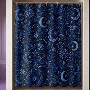 Navy celestial moon and sun shower curtain in a luxury opal bathroom with violet glass and cobalt niche