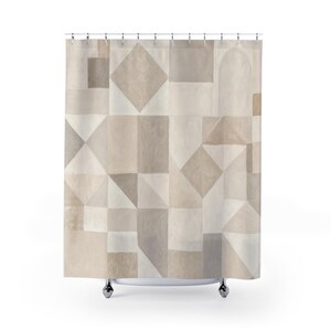 May include: A shower curtain featuring a geometric pattern of squares, rectangles, triangles, and an arch shape in various shades of beige, tan, and light grey. The curtain is suspended from a series of silver metal rings along the top edge.