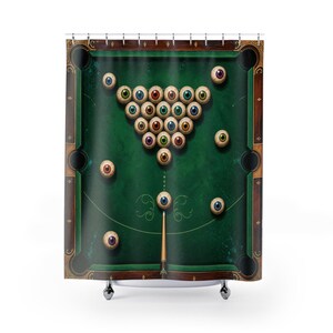 May include: A shower curtain featuring a green pool table surface with a wooden frame. The design displays a triangular rack of billiard balls replaced by realistic human eyeballs of various iris colors, with a pool cue pointing at one eyeball.
