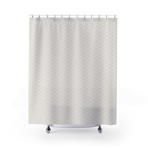 May include: A shower curtain in a neutral colour with a repeating geometric design. It hangs from a metal rail with silver rings. The pattern features small, interconnected shapes in a muted grey against a light background.