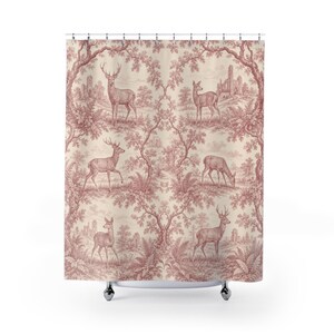 May include: A shower curtain featuring a repeating toile pattern in a muted red colour on a cream background. The design depicts various deer standing in a wooded landscape with fern foliage and distant stone ruins framed by arched tree branches.