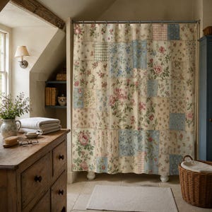 Vintage floral patchwork shower curtain in a Cotswold attic bathroom with old beams and faded blue cabinets