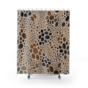 May include: A shower curtain featuring a repeating pattern of varying sizes of circles in shades of black, dark brown, and light tan. The circular shapes are arranged in a dense, scattered layout across the entire surface of the fabric.