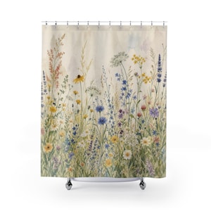 May include: A shower curtain featuring a watercolor print of a wildflower meadow. The design includes various stems of yellow, blue, and white flowers, along with green grasses and foliage, set against a light cream-colored background.