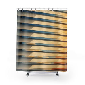 May include: A shower curtain featuring a repeating horizontal pattern of alternating golden yellow and deep blue bands. The design creates a layered effect with soft, cloud-like textures visible within the stripes, suspended from silver metal rings.