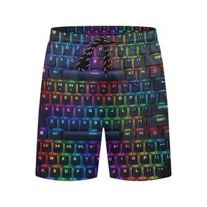 May include: Shorts featuring a vibrant, multi-colored keyboard pattern with glowing letters and symbols against a dark background. The garment includes a black drawstring at the elastic waistband, displaying a full QWERTY layout design.