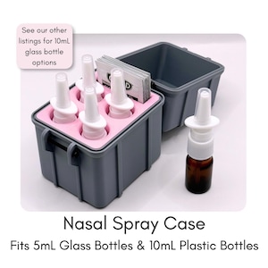 May include: A gray rectangular storage case with a pink foam insert holding three white nasal spray bottles and a stack of small packets. An additional amber glass nasal spray bottle stands next to the open case. Text reads: Nasal Spray Case. Fits 5mL Glass Bottles & 10mL Plastic Bottles.